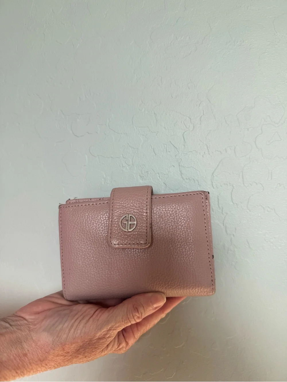 Pink pebbled leather Giani Bernini wallet featuring a snap-tab closure